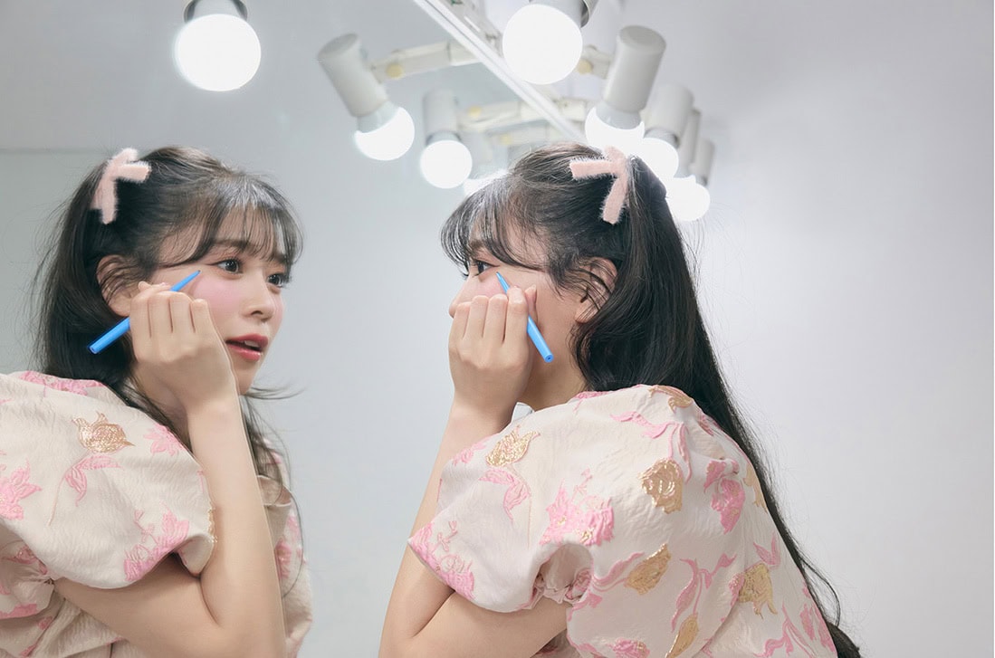 超ときめき♡宣伝部・坂井仁香が鏡越しにアイライナー「デジャヴュ 極細クリームペンシル」でアイラインを描くカット