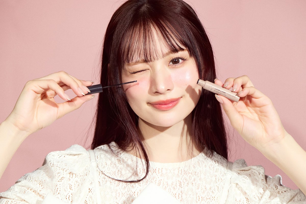 マスカラを頬に添えウインクする立花琴未のポートレート。