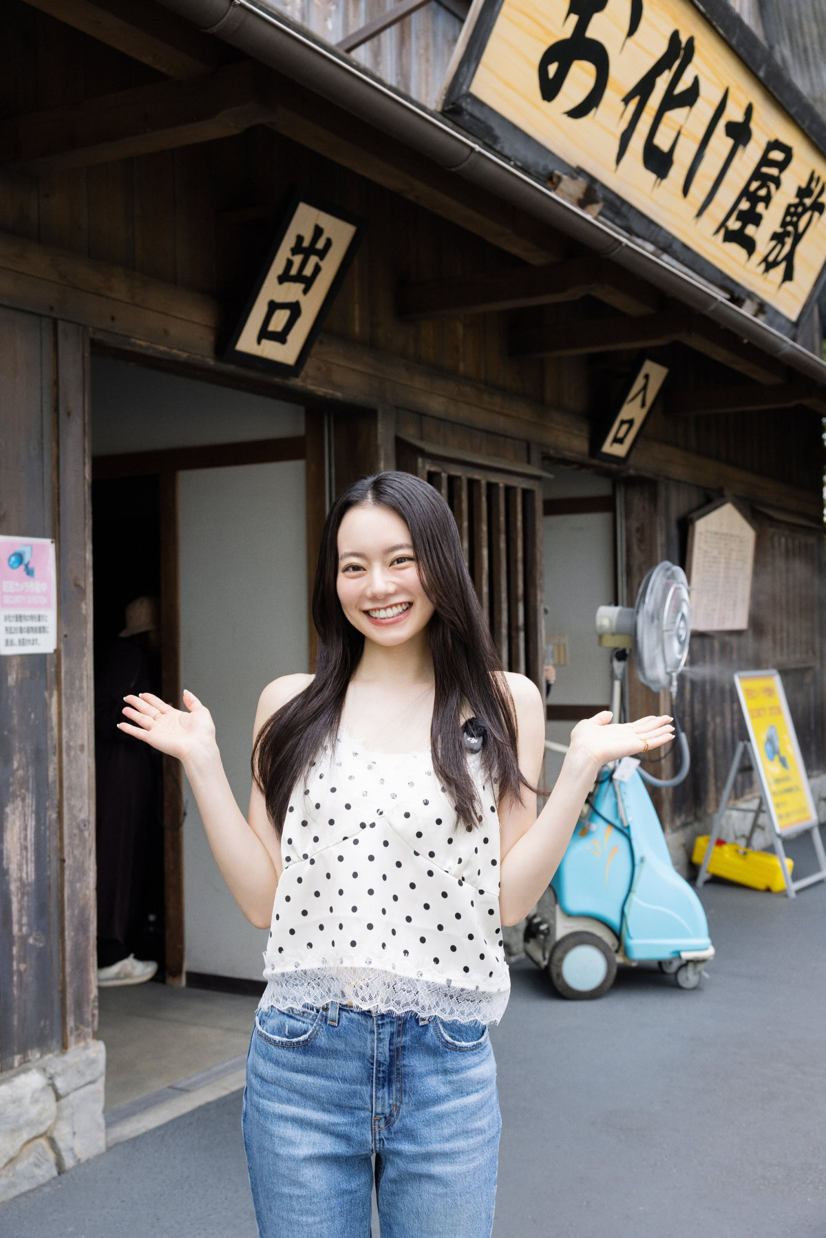 お化け屋敷の木製看板の下で両手を広げて笑顔を見せるなごみちゃん